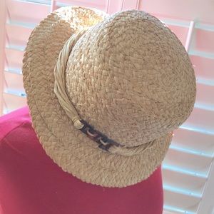 Straw hat with side embellishments.